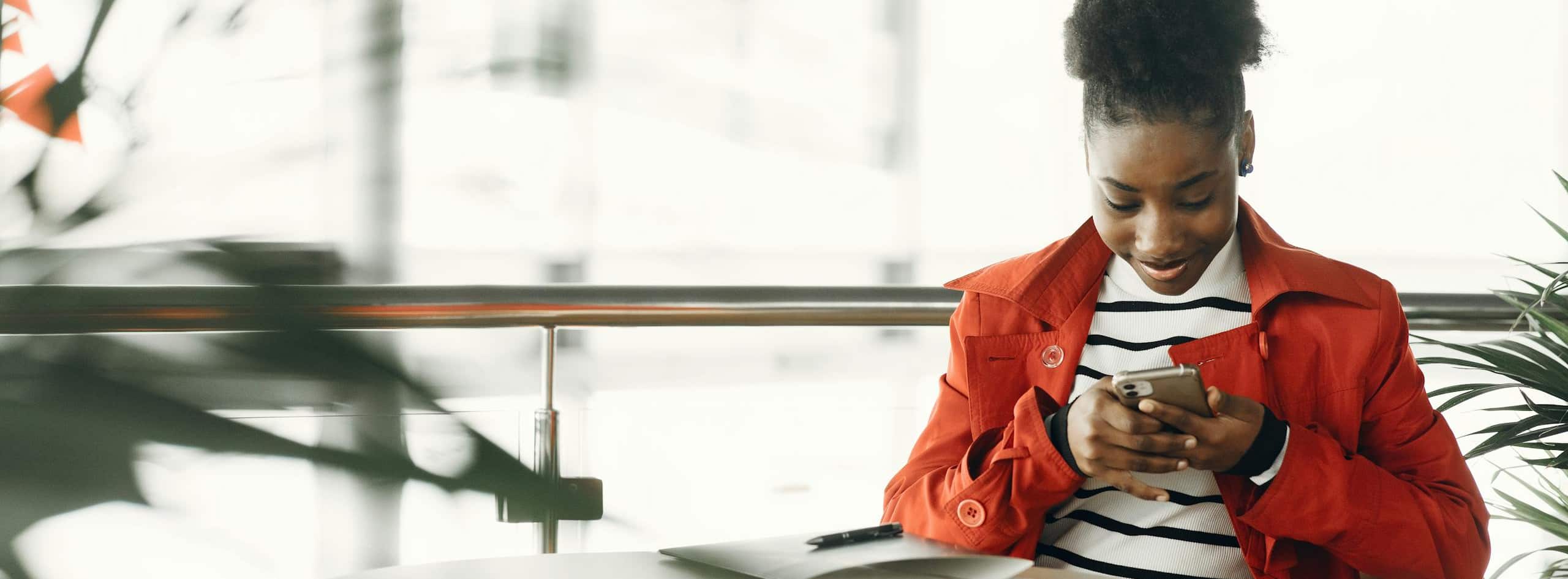 Imagem mostrando uma mulher usando um app em seu celular para aprender inglês.